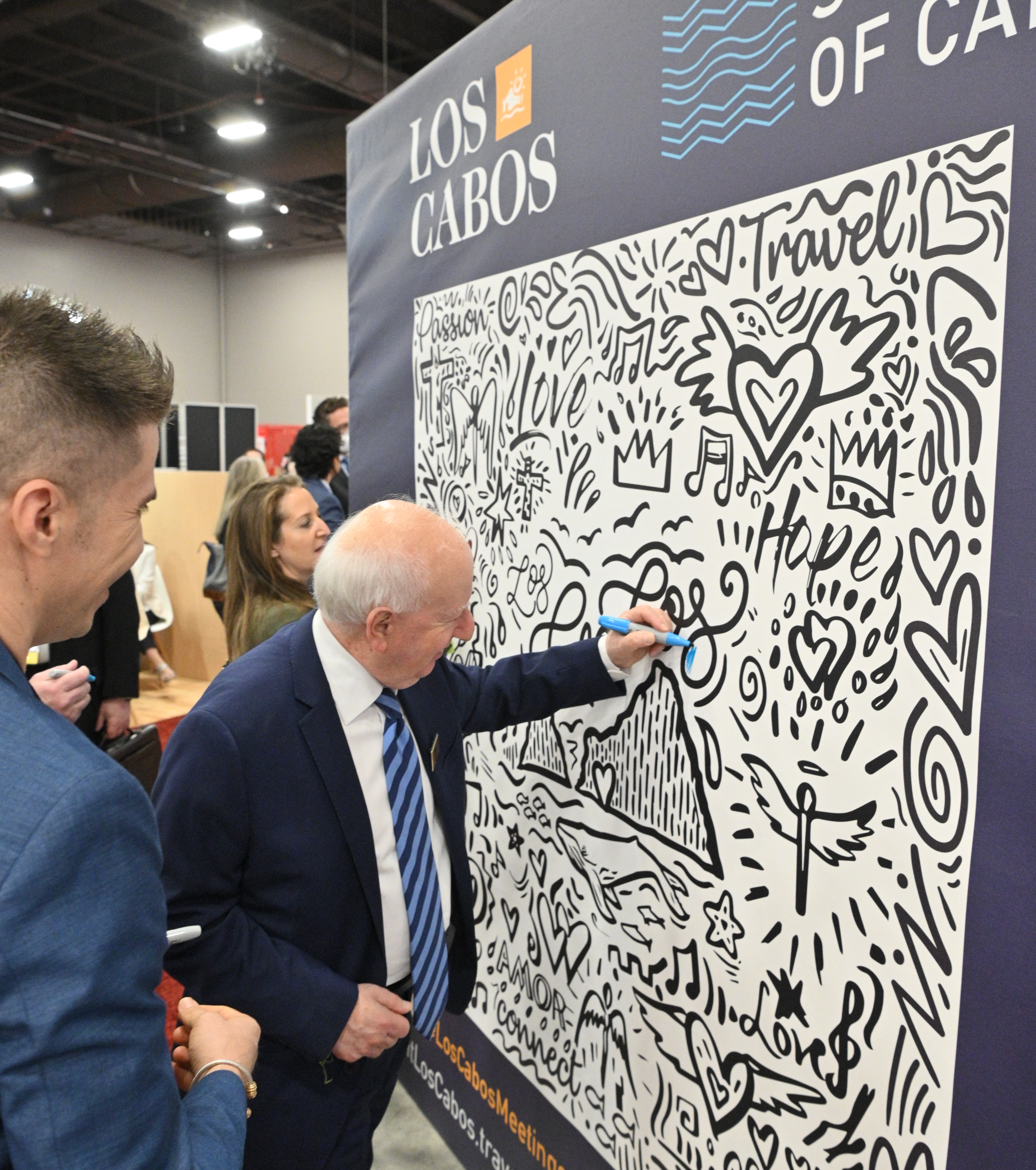 IMEX's Ray Bloom and Carina Bauer fill in the Los Cabos coloring wall